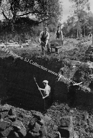 MEN DIGGING PEAT BY HAND